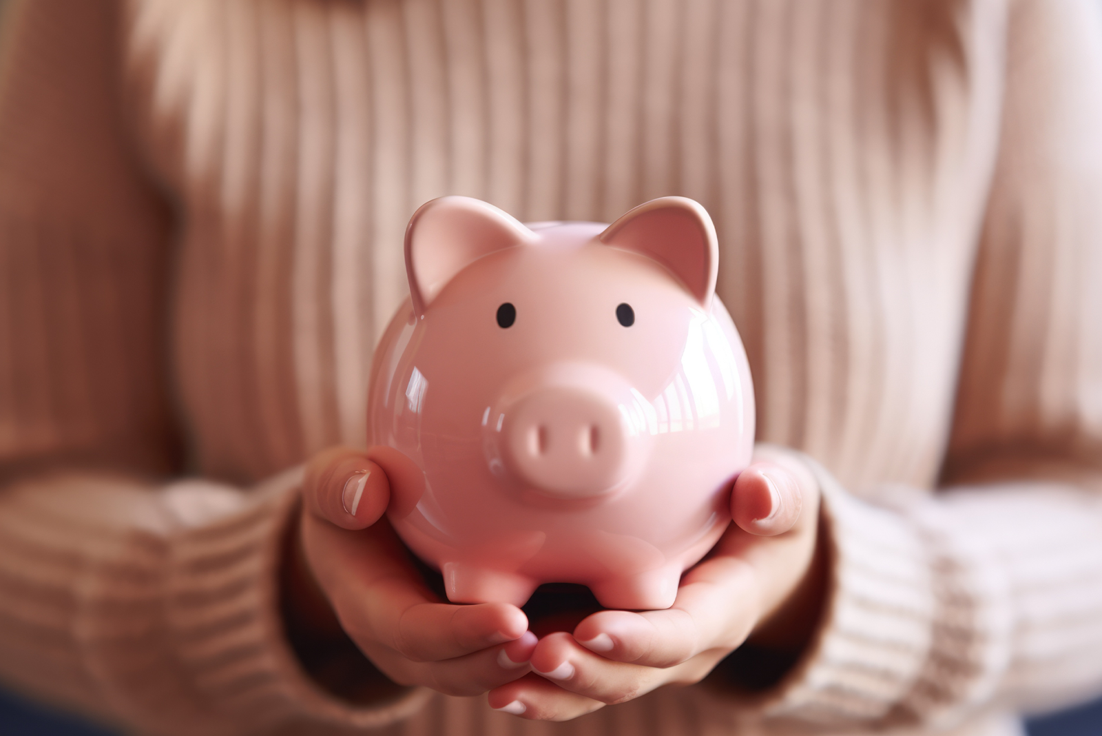 Inflation Drives 2025 HSA Contribution Limits Up Again: A female holding a piggy bank.