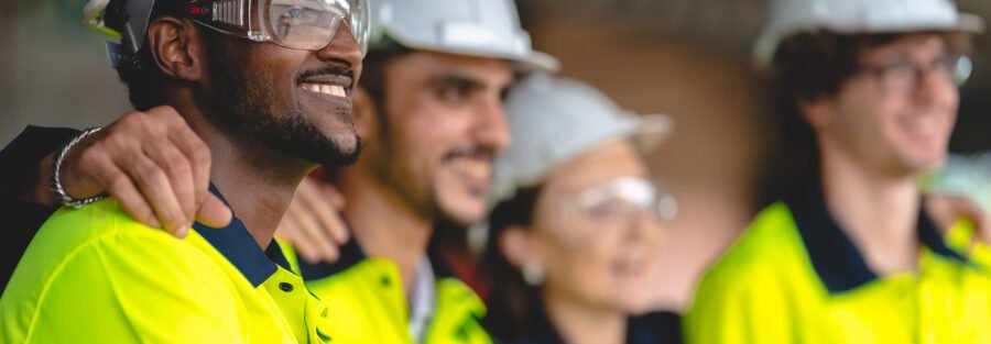 Imminent Danger on the Job Site: A group of construction workers with proper safety gear looking off into the distance.