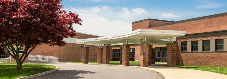 Exterior view of a school from the street for school visitor management system.
