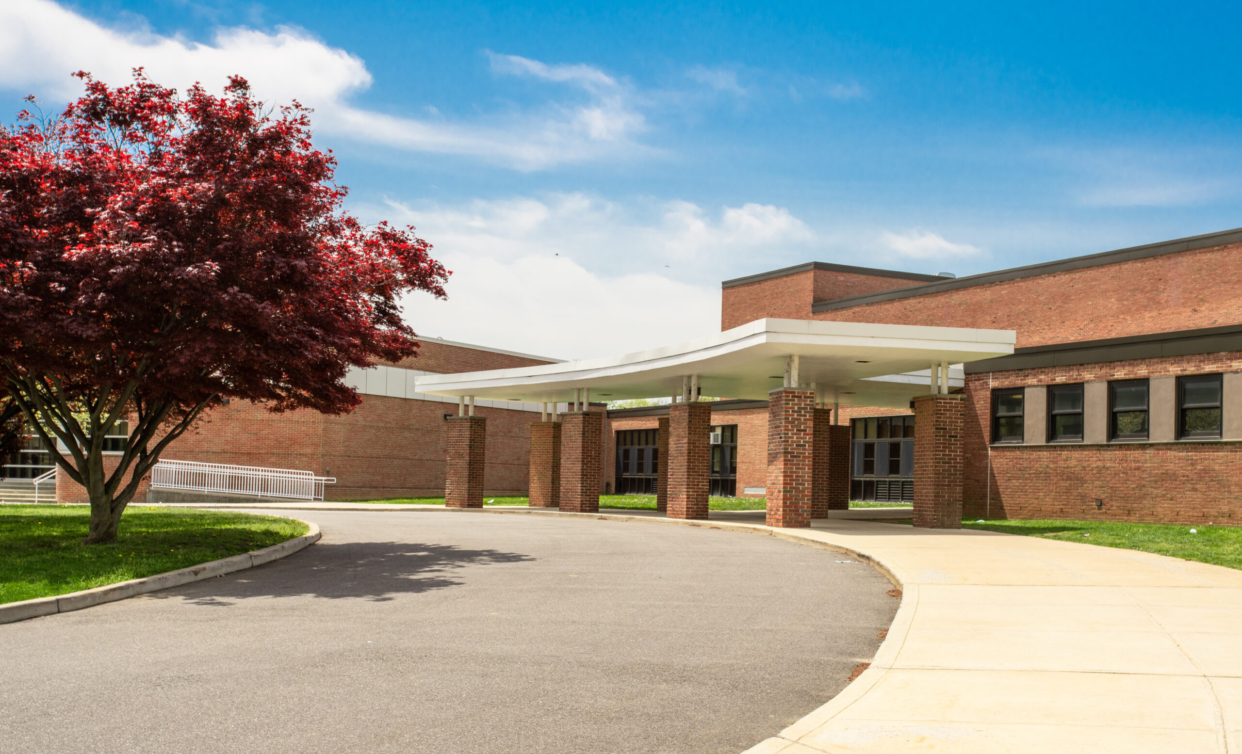 Exterior view of a school from the street for school visitor management system.