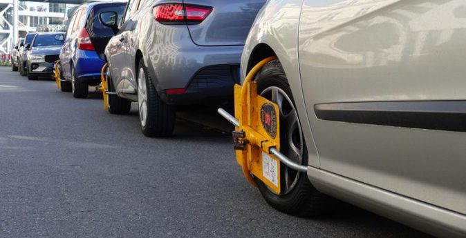 Row of parked cars showing the environment where anti-theft devices for cars are essential.