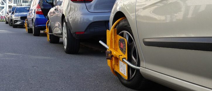 Row of parked cars showing the environment where anti-theft devices for cars are essential.